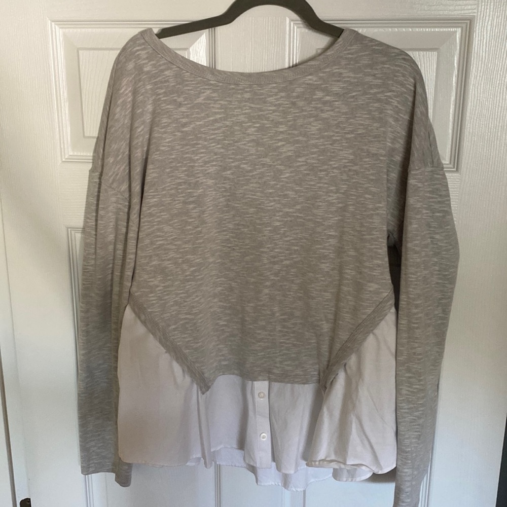 Grey sweatshirt with white tailored shirt look under